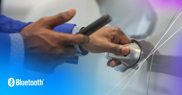 A close up on the hands of a person in a blue shirt opening a car door using Bluetooth Channel Sounding enabled digital key.